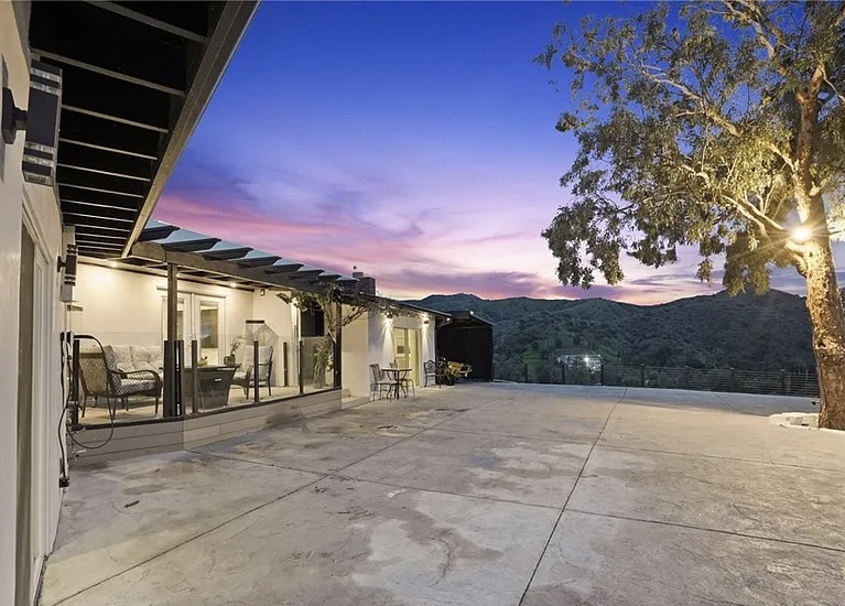Spacious outdoor terrace with mountain sunset view