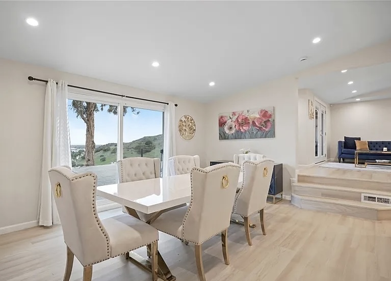 Bright dining area with hillside views